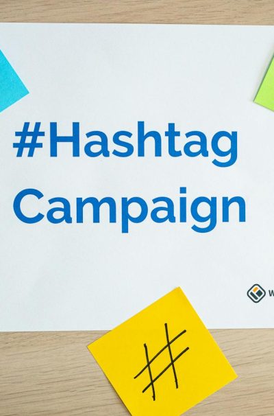 Colorful sticky notes arranged around a hashtag campaign sign, ideal for social media marketing concepts.